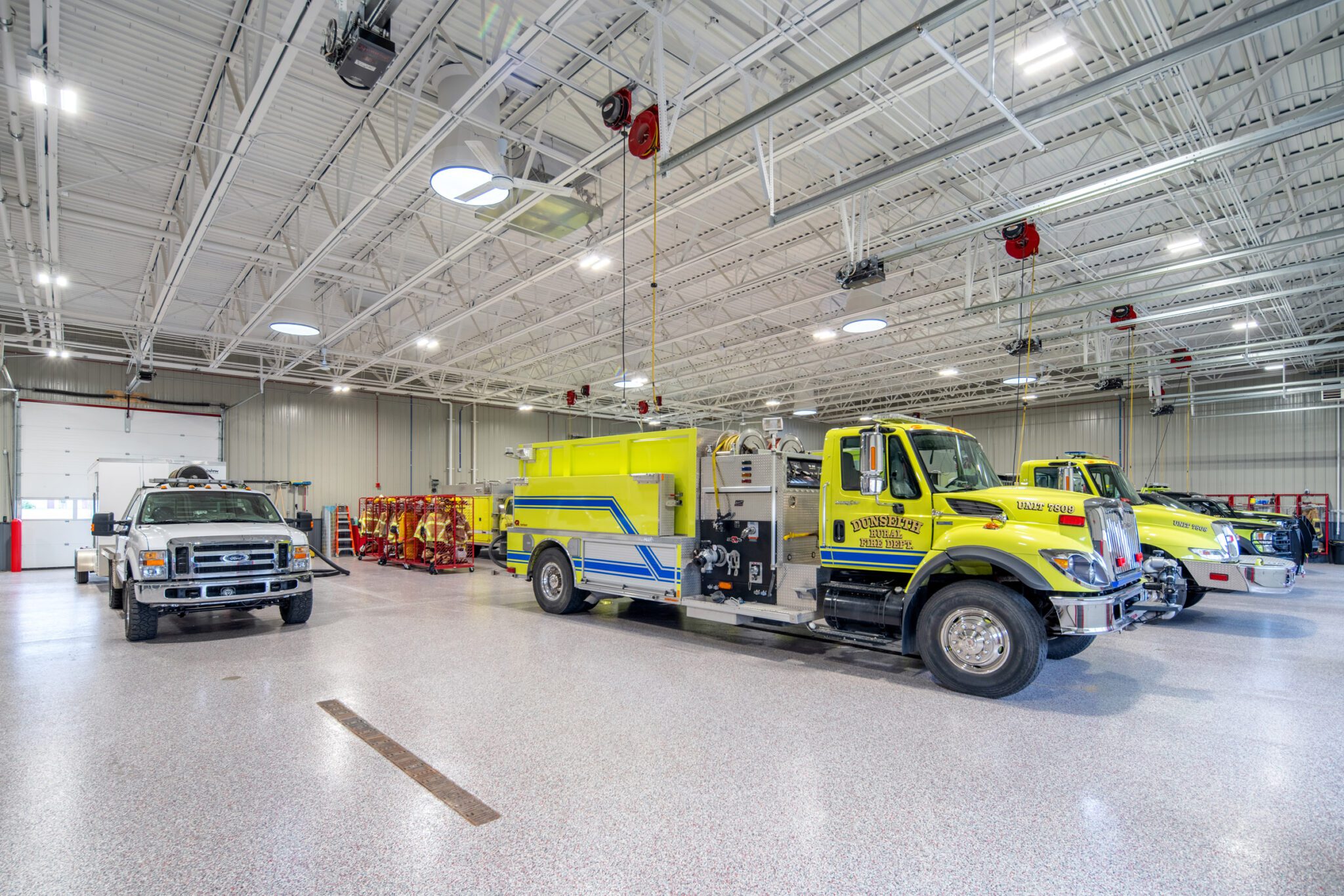 a yellow fire truck parked inside of a garage - Dunseith Emergency Response Center