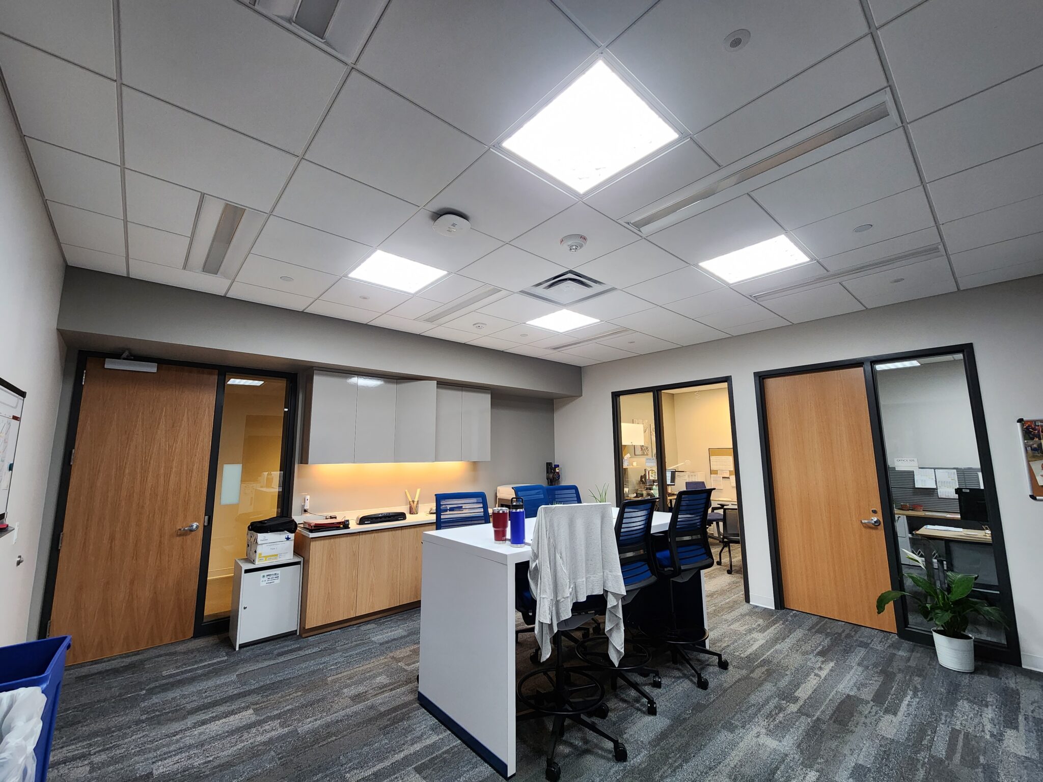 an office with a desk and chairs and a skylight - City of Plymouth Community Center Project