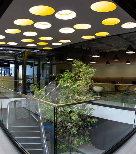 a glass railing with a plant on top of it - daylight lighting systems